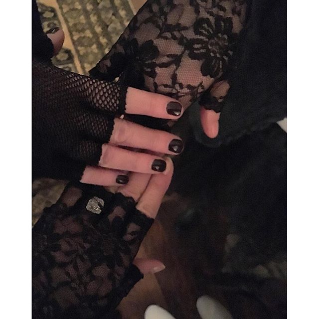Madonna fingerless lace gloves and dark nail polish