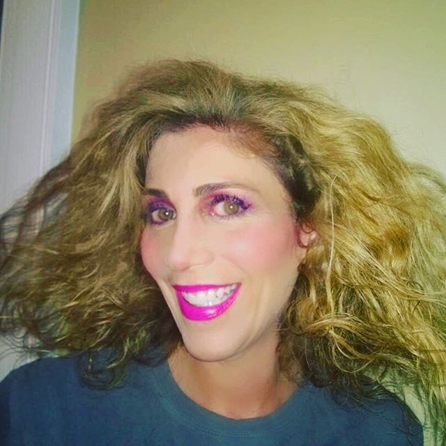 Lauren Dimet Waters in 80s makeup pink lipstick and big hair