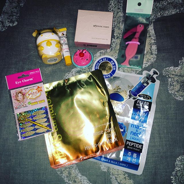 Korean beauty products on a bed masks lotions