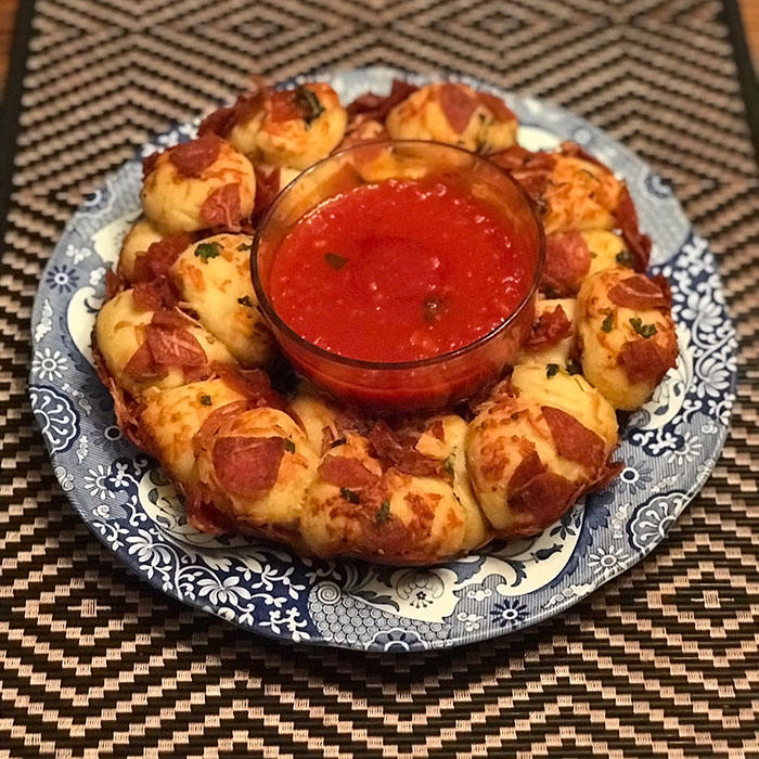 Kid Friendly Pepperoni Pizza Monkey Bread served with sauce