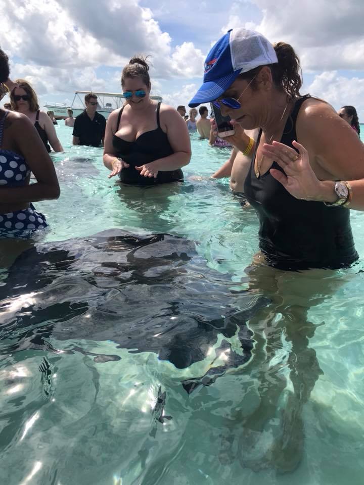 Permission To Hustle cruise experience Lauren Dimet Waters with Stingray on Cayman Islands