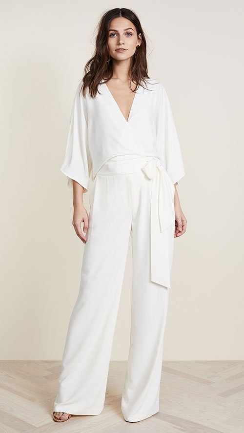 Lupita Nyong'o White Jumpsuit halston wrap front wide leg pant on model