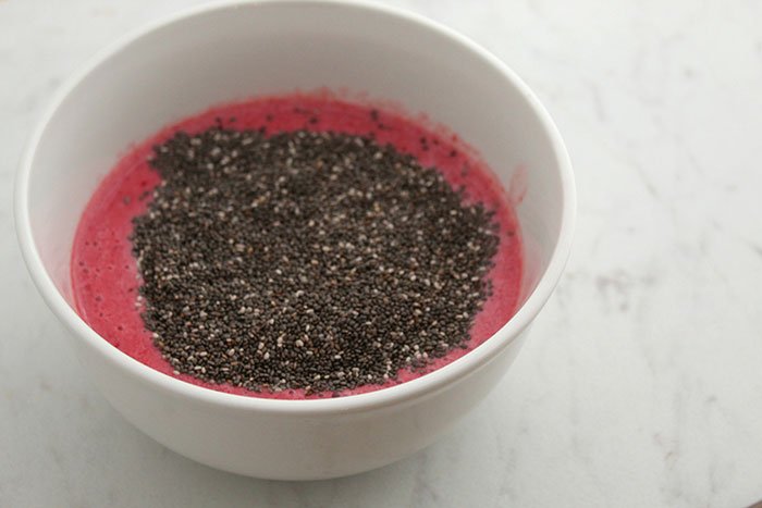 Raspberry Mixture and Chic Seeds in white bowl on white marble 