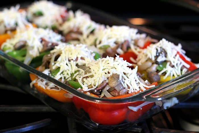 Keto Philly Cheesesteak Stuffed Peppers prepared for oven in a square glass pan