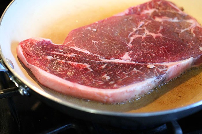 strip steak in oil in a pan