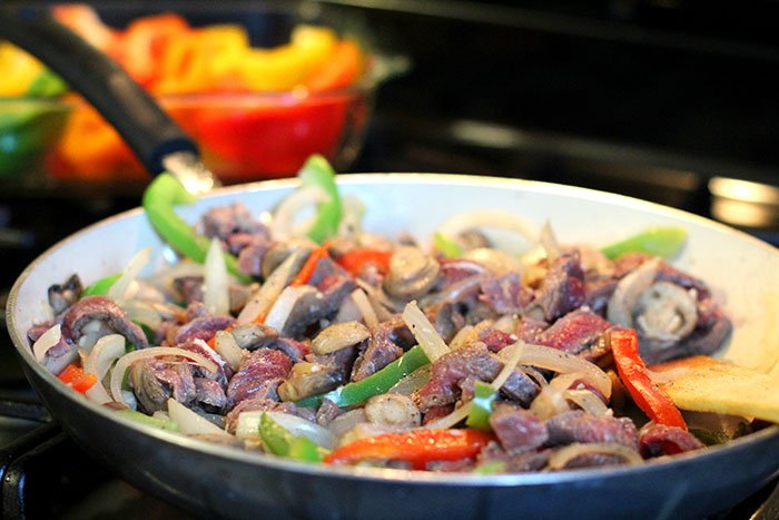 Keto Philly Cheesesteak Stuffed Peppers Recipe mixed meat and vegetables in pan before stuffing