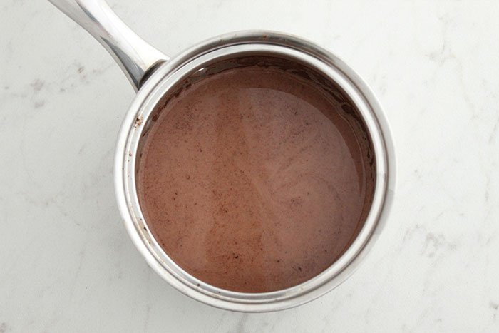 saucepan with melted chocolate on marble surface Raspberry Chocolate Chia Pudding 