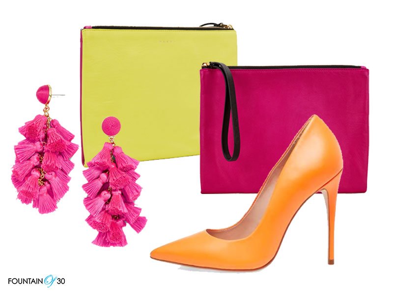 bright neon colors hot pink earrings yellow and pink wrist bag and orange high heel pumps