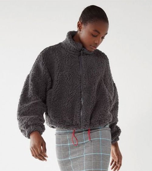 model in grey fuzzy fleece zip bomber jacket and plaid pencil skirt