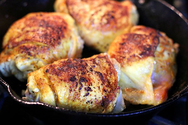 Browning chicken in a cast iron skillet