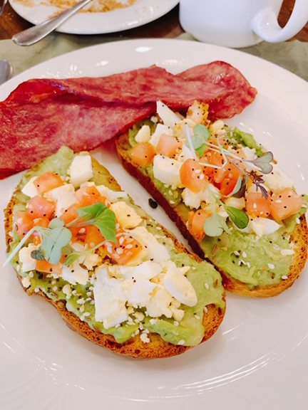 Avocado toast and turkey bacon on a plate