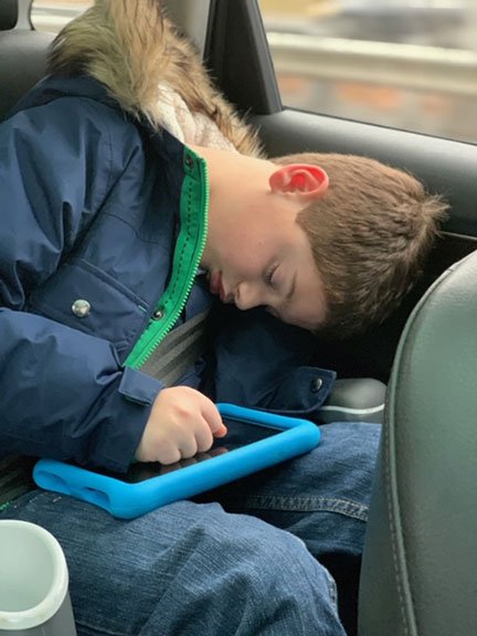 boy asleep in car