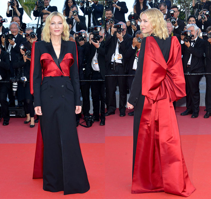 cate blanchett wearing a black and red satin jumpsuit with an oversize red bow on the back