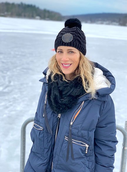 woman on hat and coat in the snow