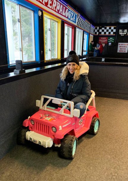 adult woman in pink kid's car