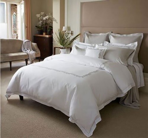 white linens in a luxurious hotel room with a window