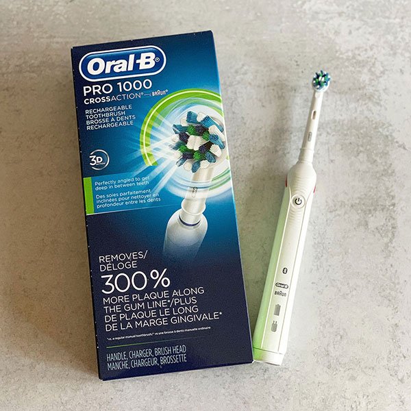 powerup oral-b pro 1000 white toothbrush and blue product package