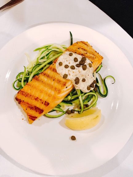 grilled salmon with lemon caper sauce over zucchini noodles