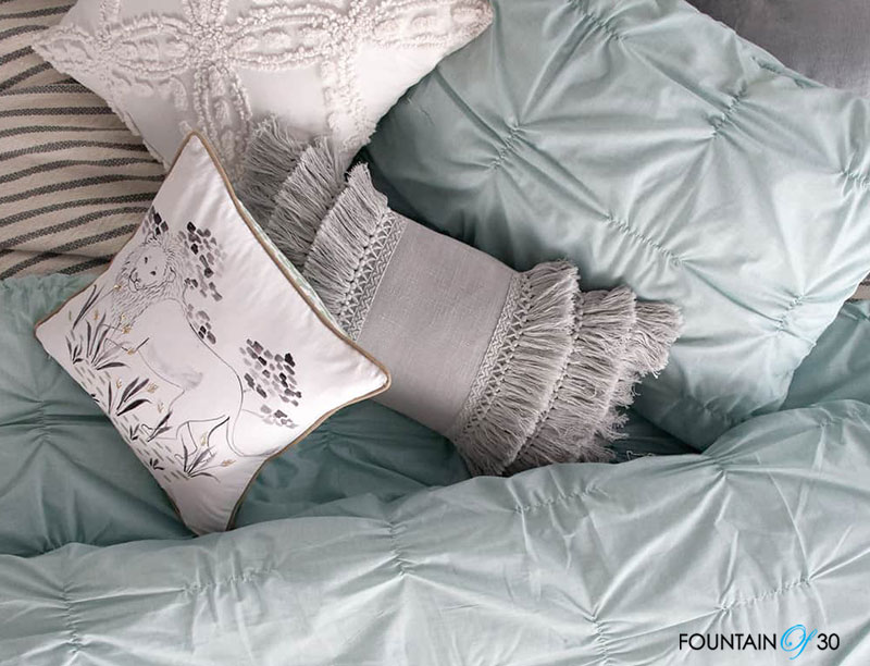 How To Use Textiles In Your Home grey blue pillows on bed