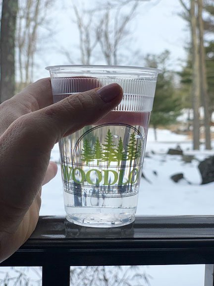 a cup of water in a Woodloch cup