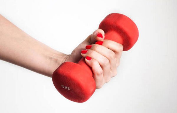 fit and fab woman hand with red dumbbell red nail poilsh fountainof30