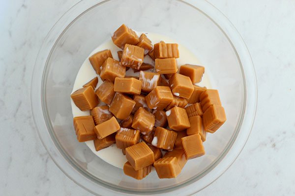 gluten free dessert recipe caramel squares and cream in a bowl