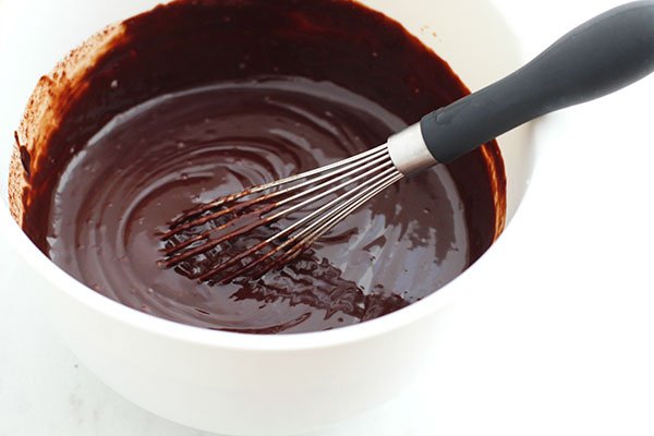 chocolate and wisk in white bowl