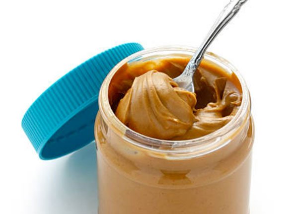 unhealthy health foods lowfat peanut butter with spoon in jar fountainof30