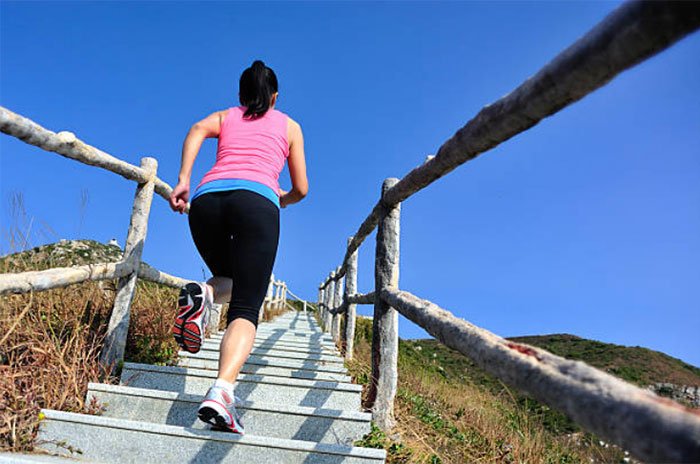 exercise Weight-Bearing Aerobics woman running up stairs outdoors blue sky