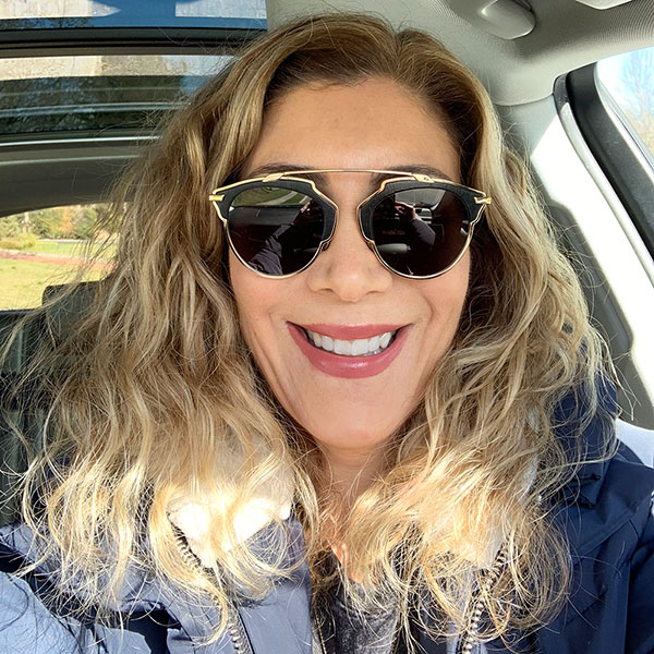 Woman in suglasses wearing SmileDirectClub aligners