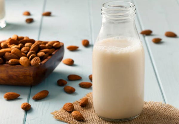 unhealthy health foods almod milk in glass bottle almonds fountainof30