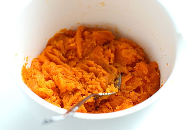 Smash sweet potatoes with a fork until smooth.