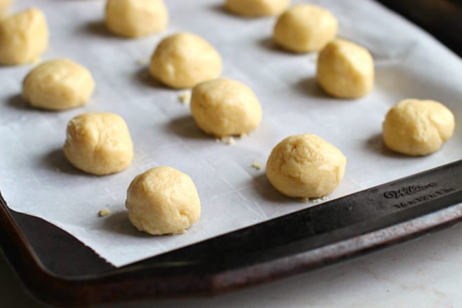 rolled cookie batter balls on parchment fountainof30