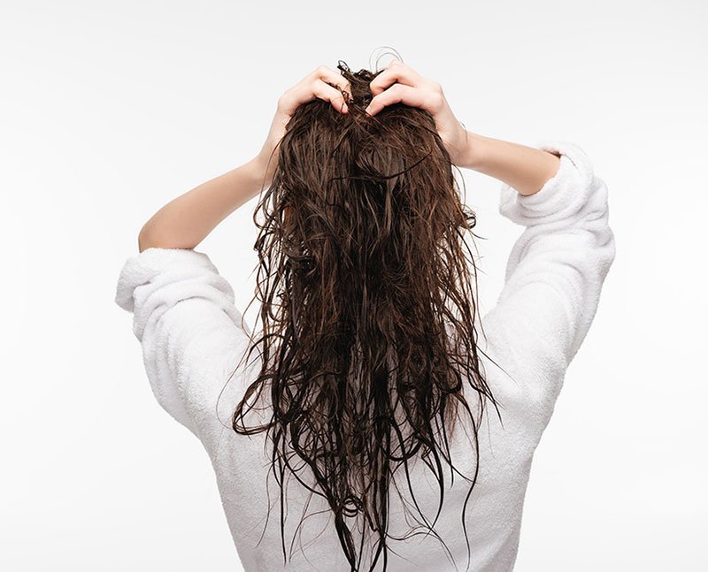 air drying hair woman with brunette wet hair back of head fountainof30
