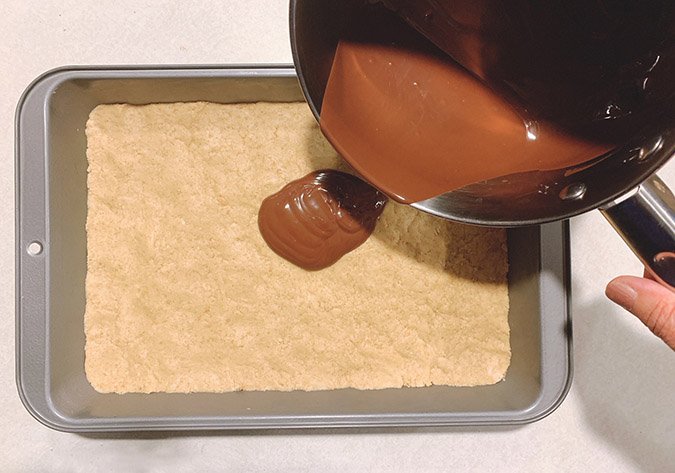 Immediately pour melted chocolate chips over batter.