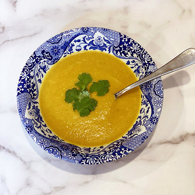 Spiced Curry Soup with cilantro in blue bowl fountainof30