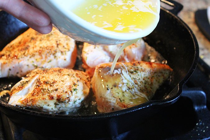 garlic butter over chicken in skillet fountainof30 chicken 