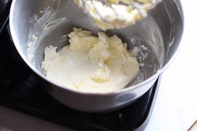 mising frosting for cupcakes in a bowl