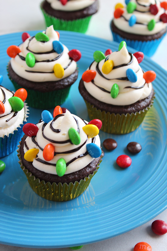 christmas lights cupcakes serving on a blue plate fountainof30