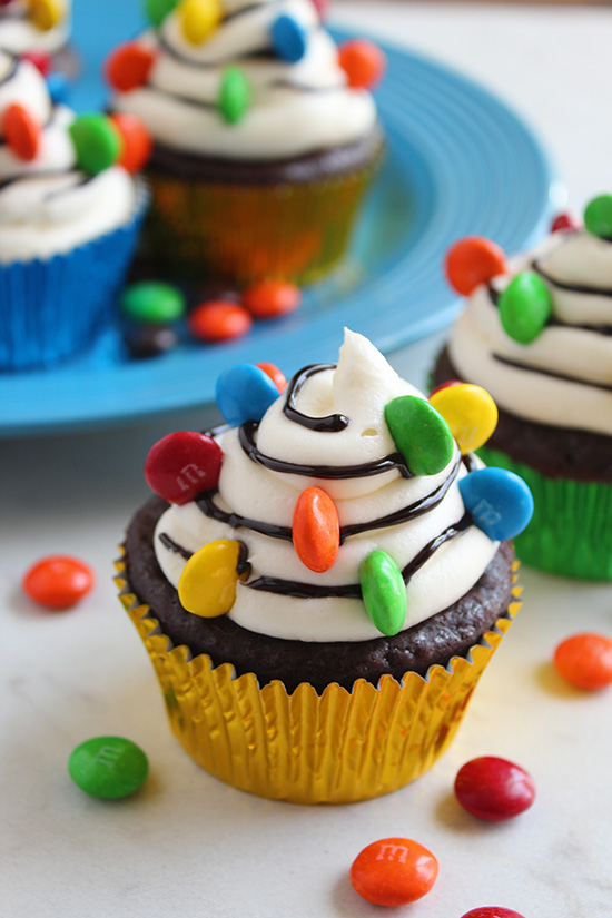 close up christmas lights decorated cupcakes