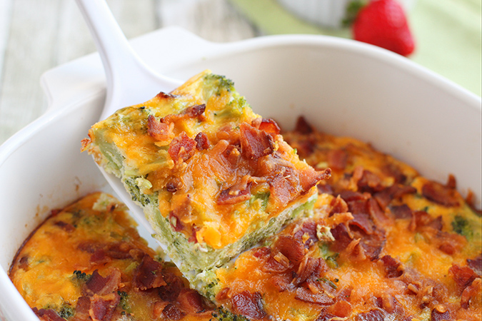 serving a slice Keto Overnight Breakfast Casserole fountainof30