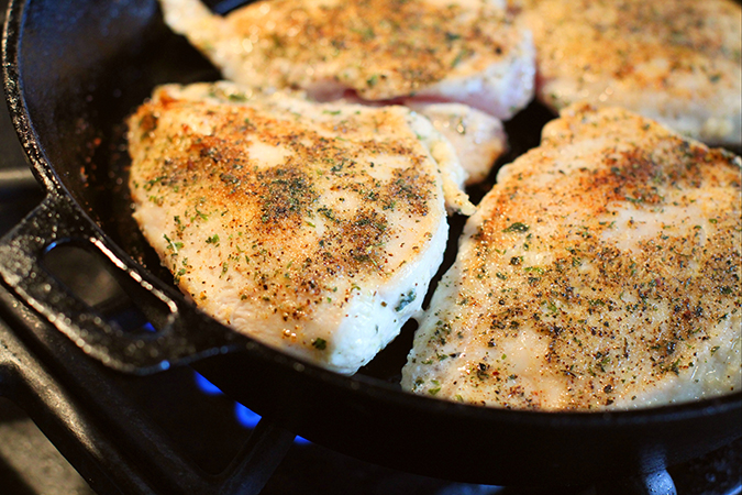 seasoned chicken breast in skillet fountainof30