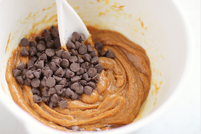 mixing chocolate chips with batter fountainof30