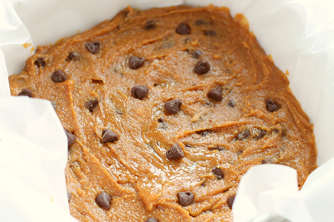 peanut butter blondies batter in parchment lined pan fountainof30