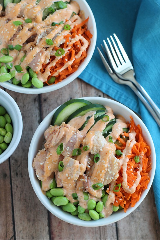 2 salmon rice bowls with two forks fountainof30