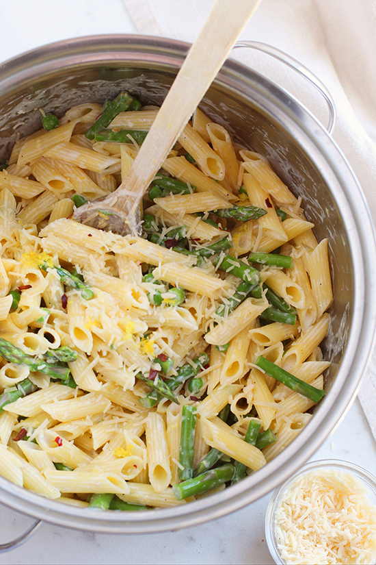 mixing lemon asparagus pasta with cheese fountainof30