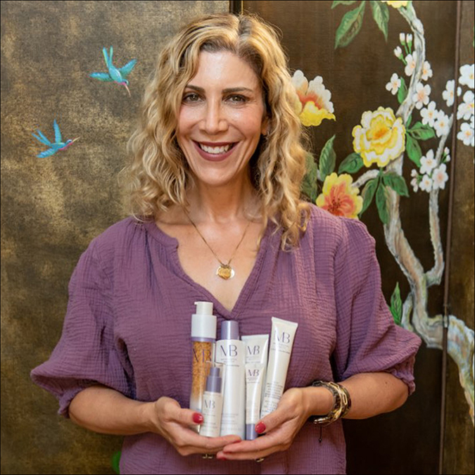 lauren dimet waters holding meaningful beauty products fountainof30