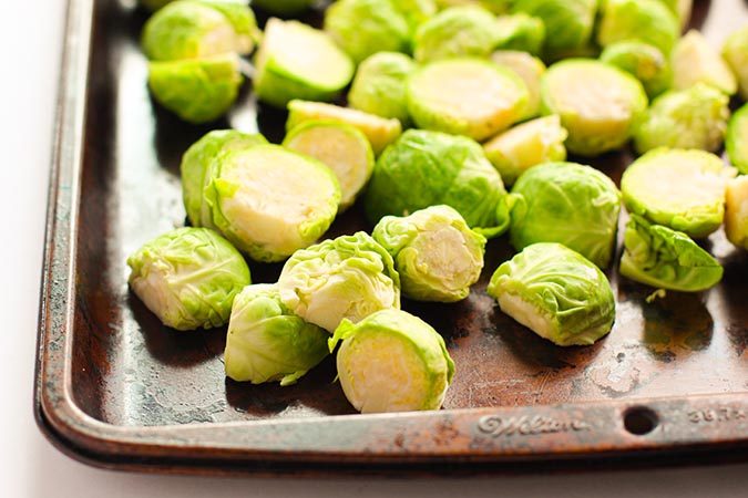 Brussels sprouts in halves on baking sheet fountainof30