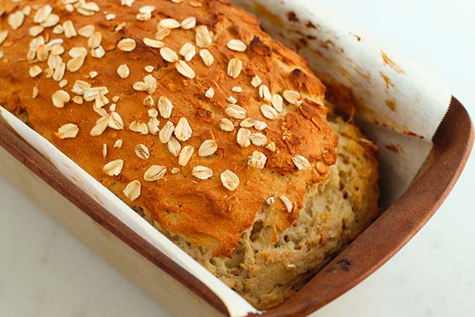 baked oat bread in loaf pan parchment fountainof30