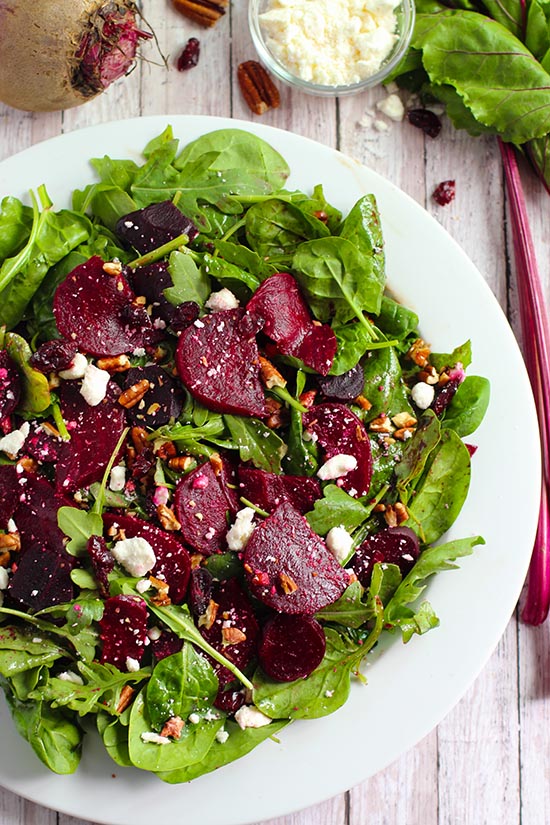 toss beets and dressing with other ingredients with mixed greens fountainof30